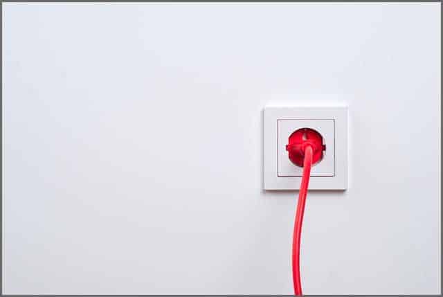 An image of an electric socket connected to the red power cable