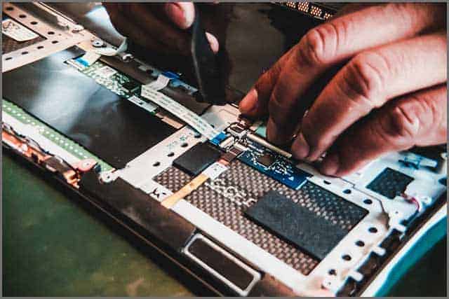 An image of a technician plugging ribbon cable