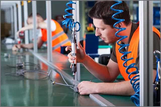 Men during precision work on the production line