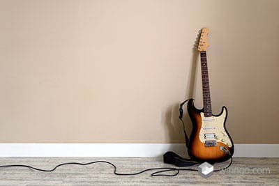 Guitar cable with the guitar and the white background