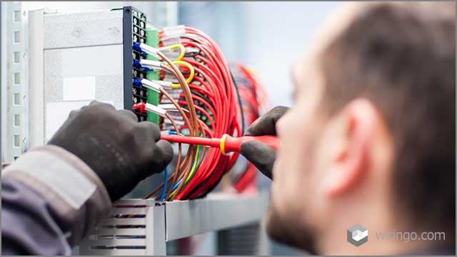 electrician engineer works with electric cable wires of the fuse switch box