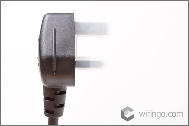 A black over-molded plug in front of a white backdrop
