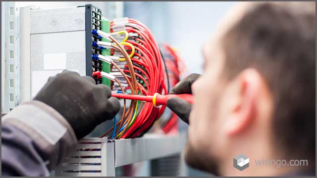 Electrician engineer works with electric cable wires