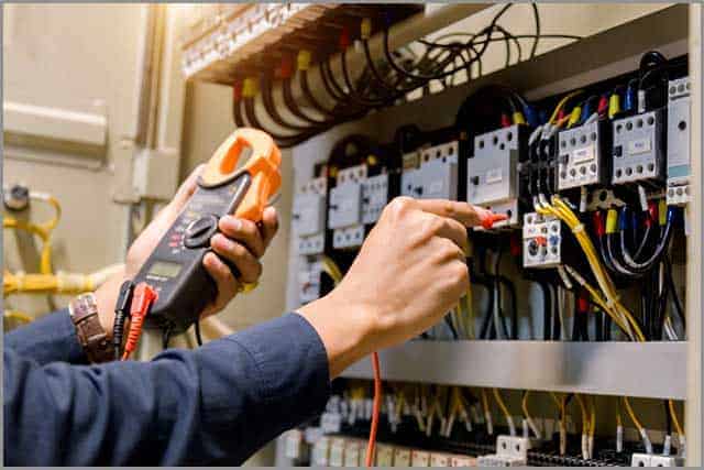 An engineer working on the measurements of the wires