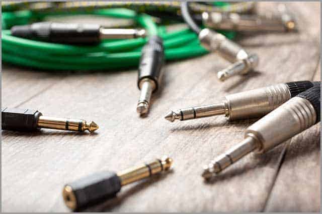 Several ¼ inch audio cables plugs