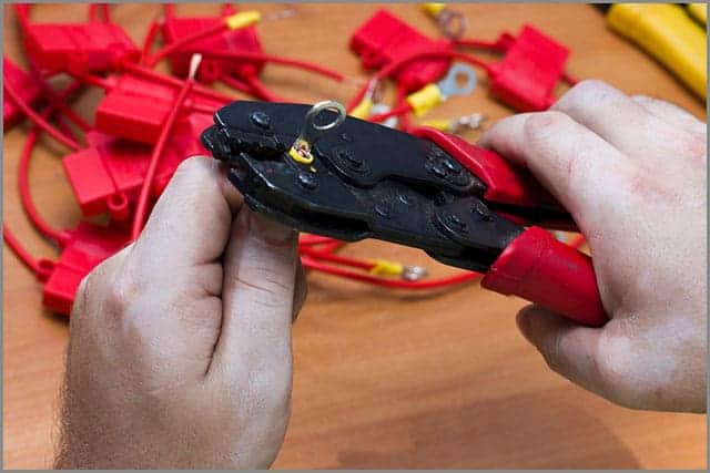 Man Crimping An Automotive Terminal to A Cable