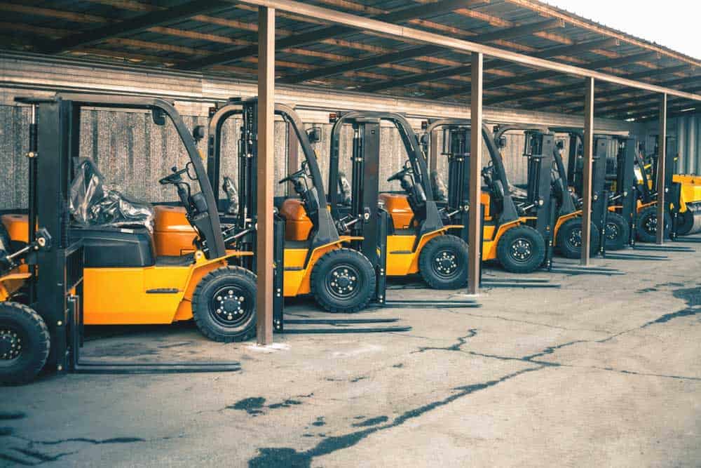 Several forklifts parked inline