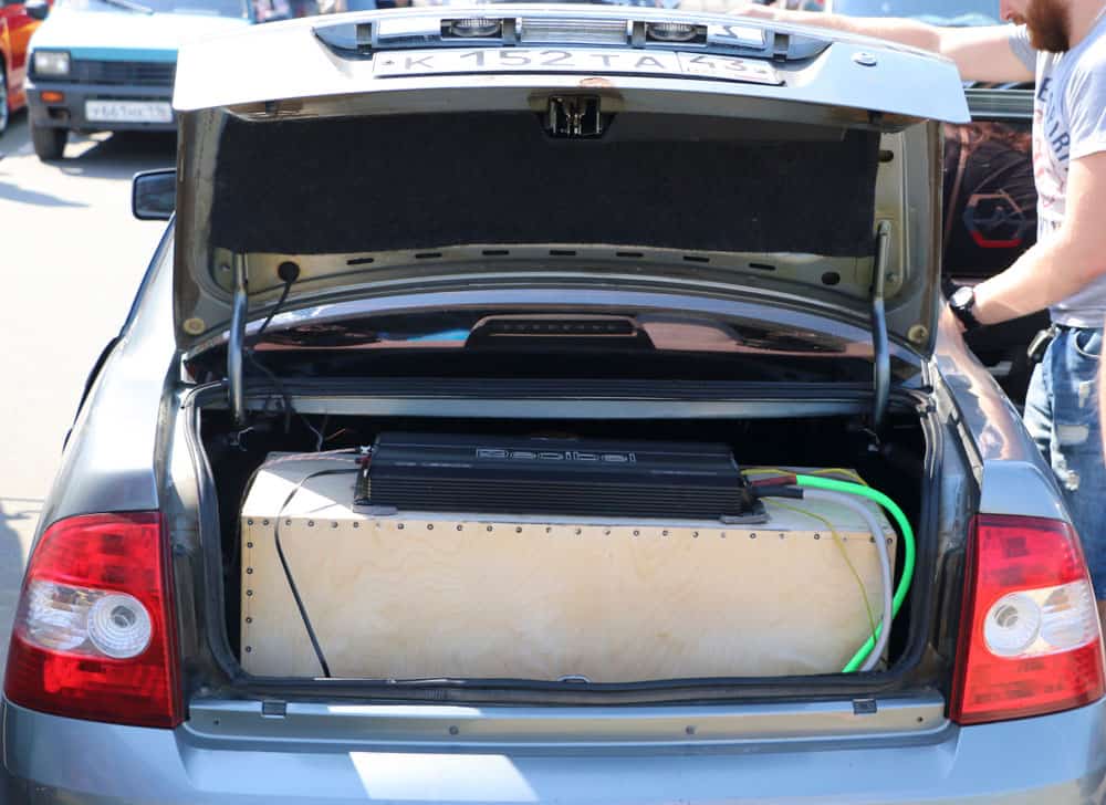 Car with an aftermarket amplifier in the trunk.