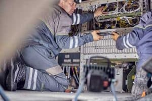 Technicians fixing on an aircraft’s electrical system