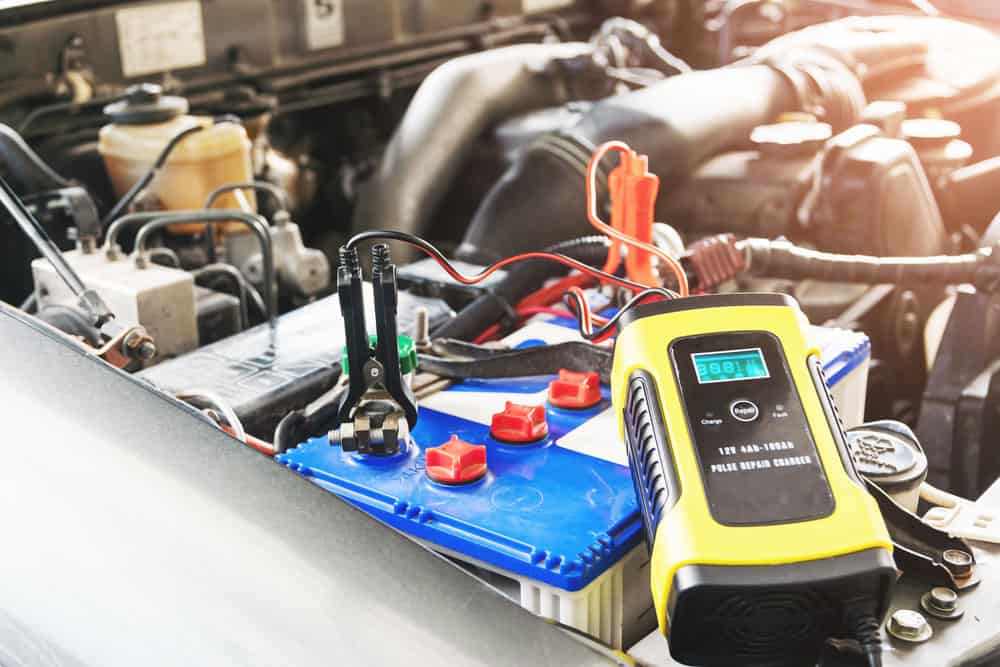 A mechanic works with car electrics