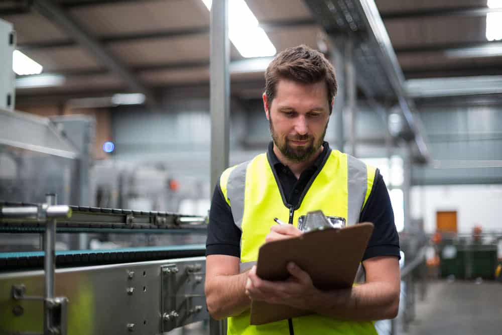 A worker writing something on the clipboard