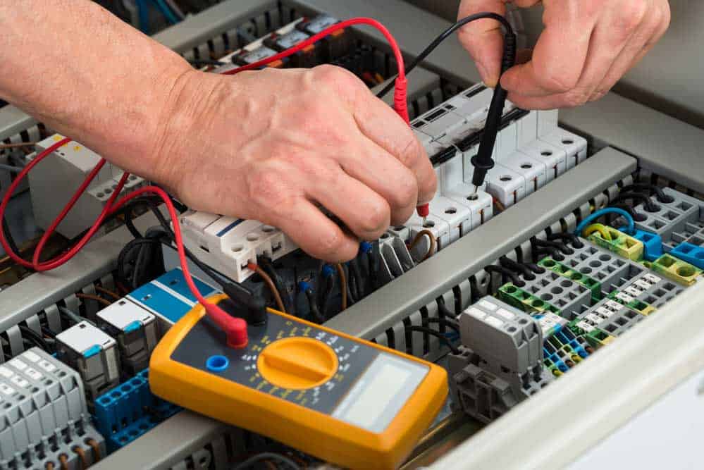 Electrician checking fuse box