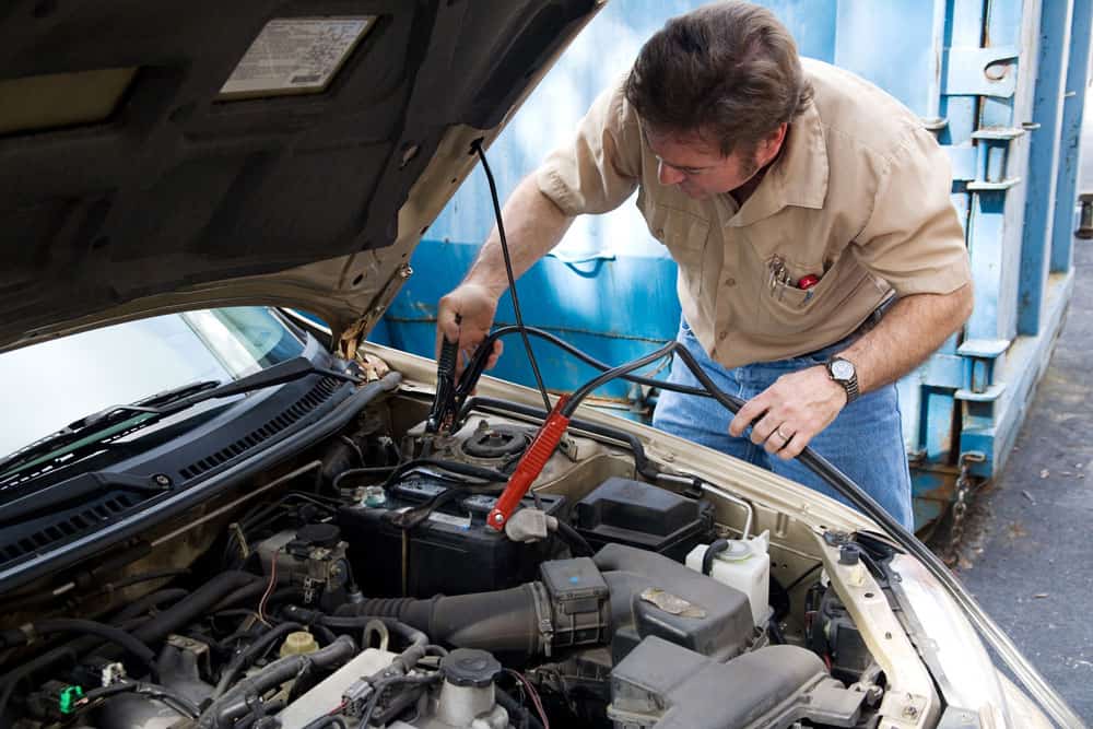 Serviceman working with auto cables