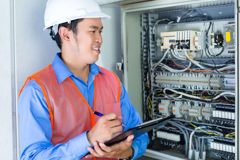 A worker checking the panel