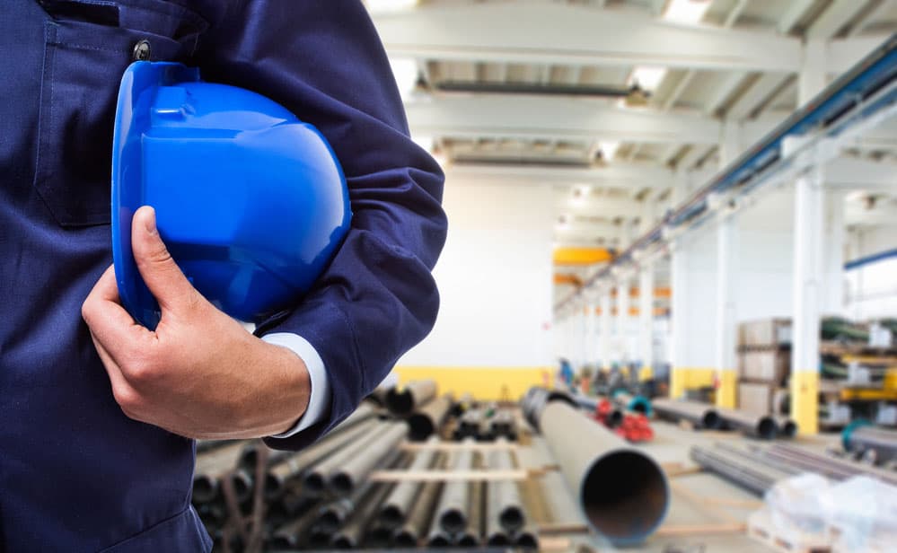 A worker holding his helmet