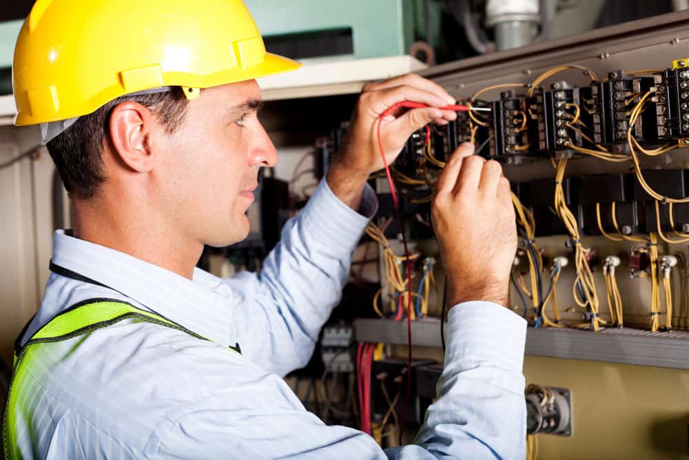 An electrician testing a machine