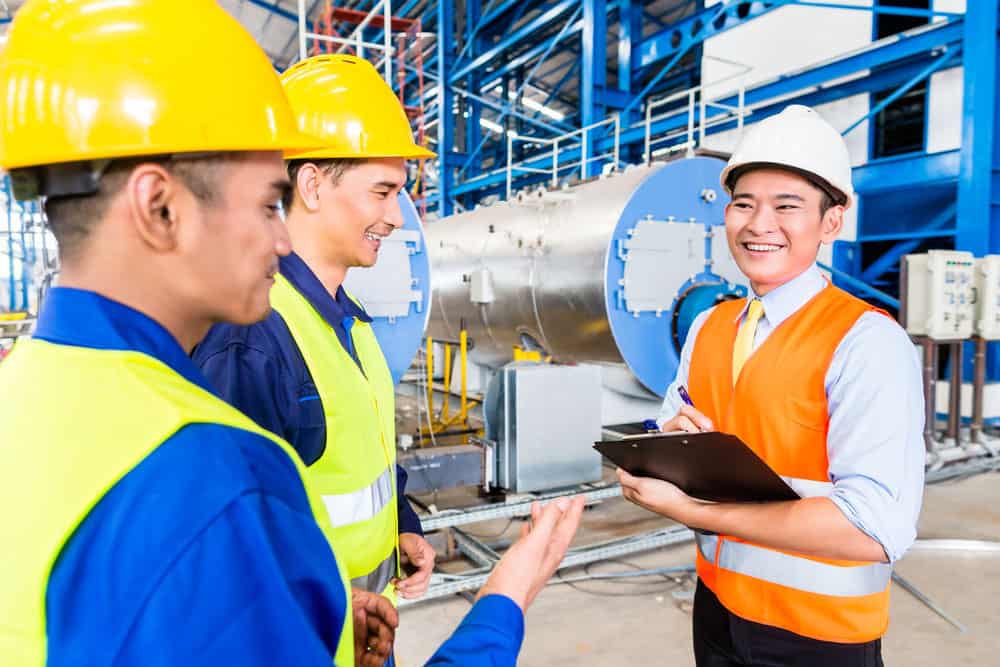 Factory workers with an engineer