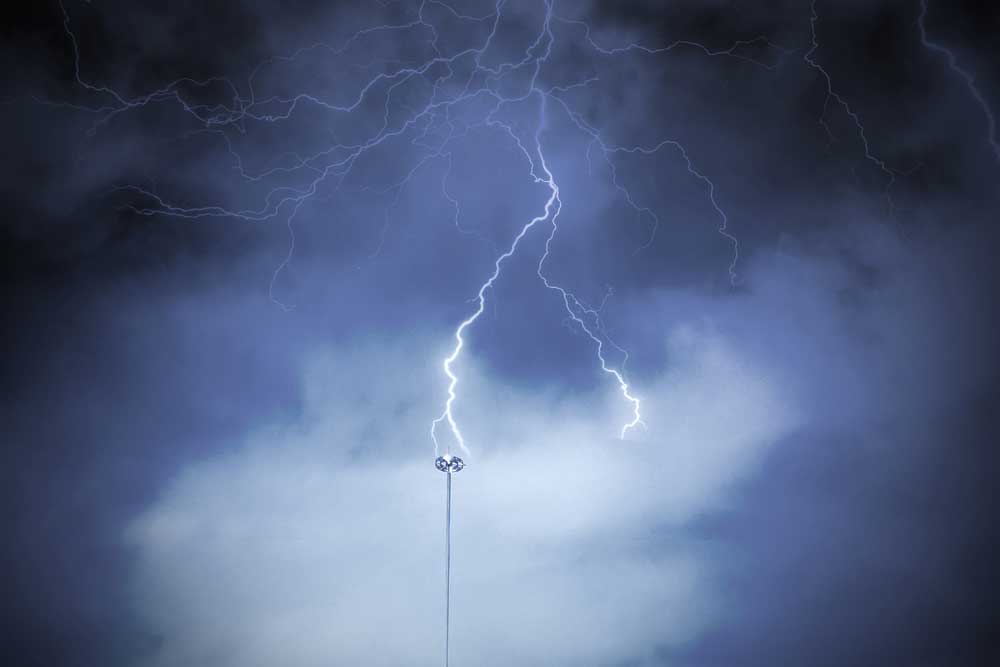 lightning rod against a dark cloud sky