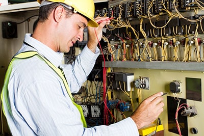 An electrician checking an industrial machine