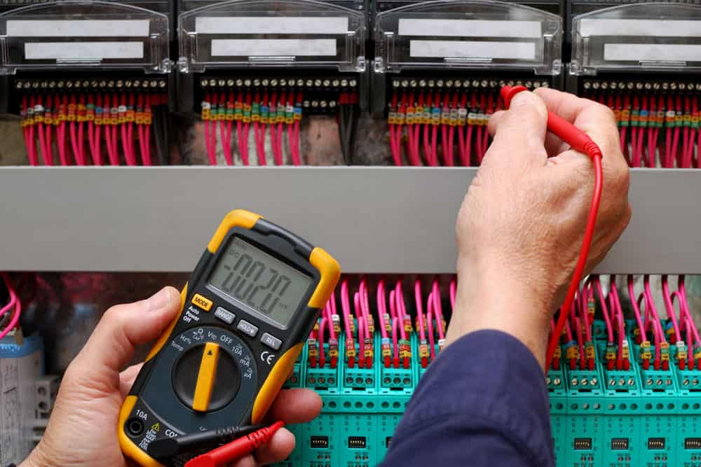 Technician testing a control panel