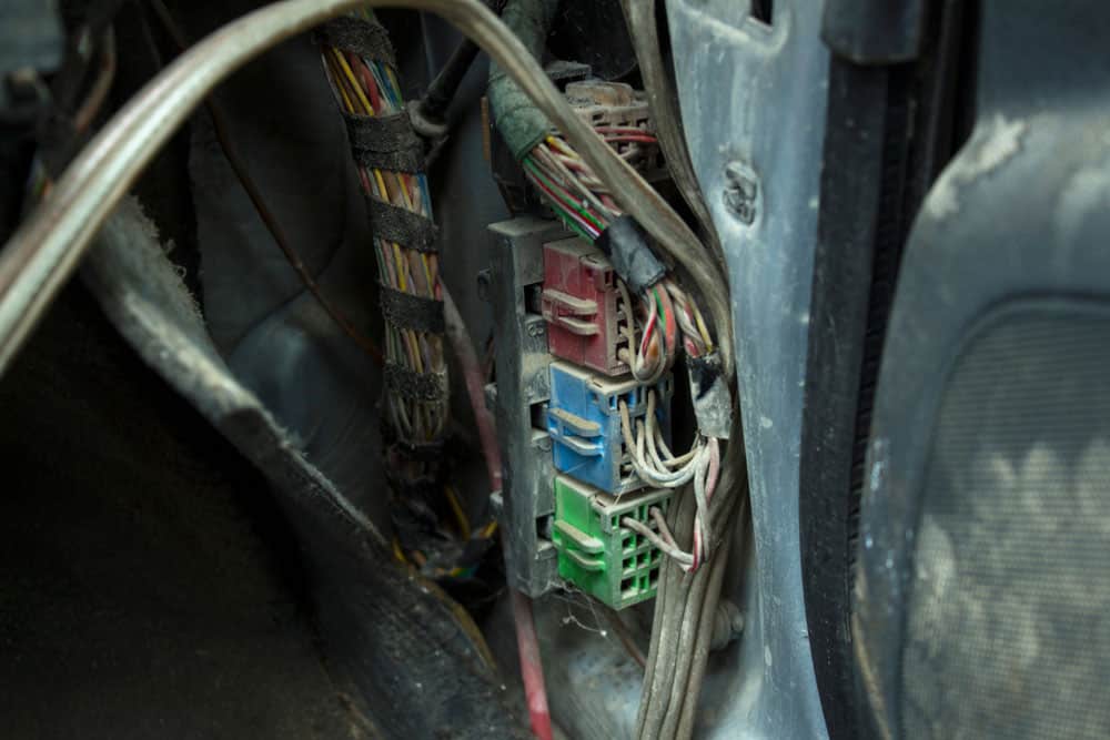 Dusty plugs wires under a rug