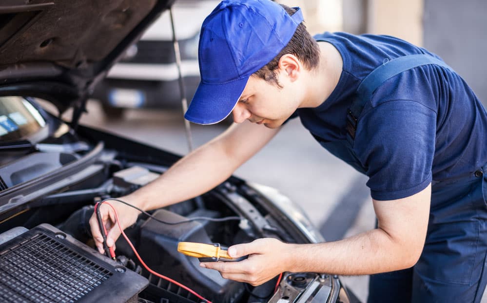 The electrical worker checks the car wiring